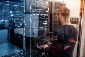 man working on computer in server reflection